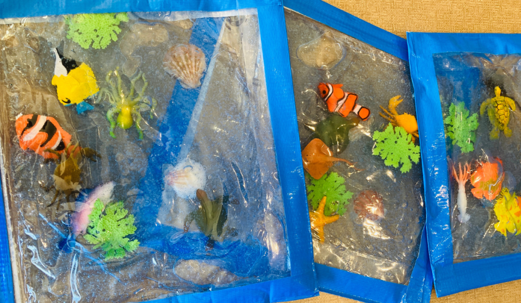 Photo shows sensory bags filled with blue hair gel and ocean animals.