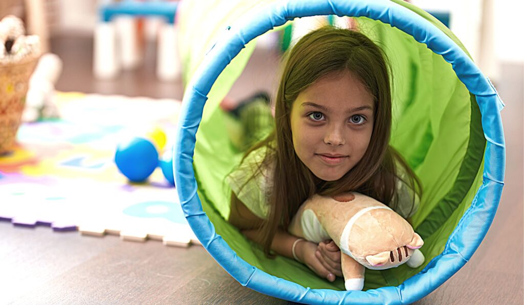 Photo shows a young girl in a tunnel