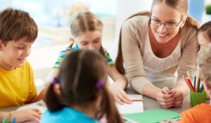 Images shows a teacher and several students talking