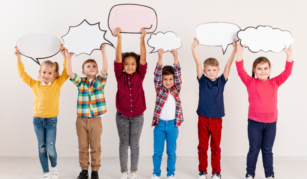 Six young students are holding speech bubbles above their heads