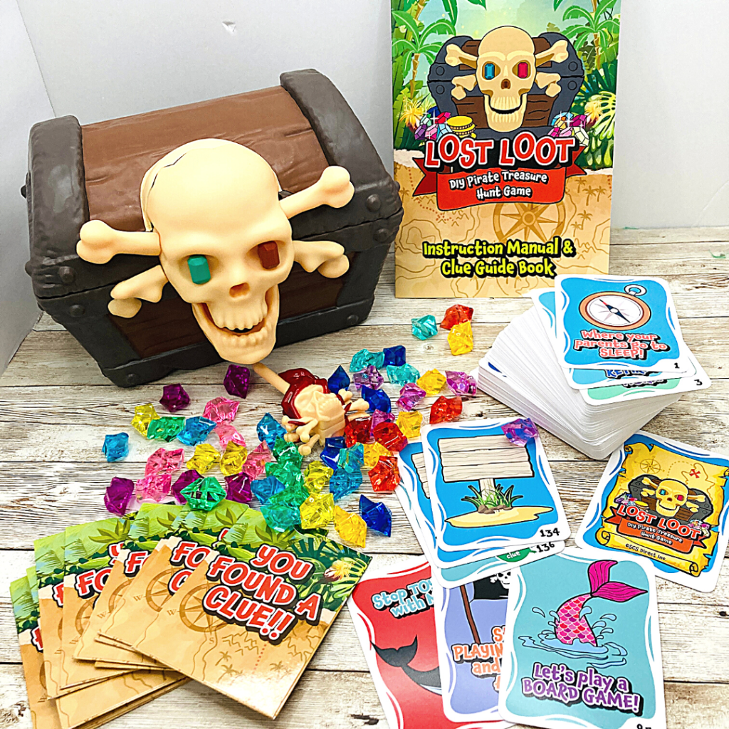 Image shows a pirate treasure chest, keys, gems, and clue cards