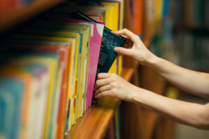 image shows a person choosing a library book