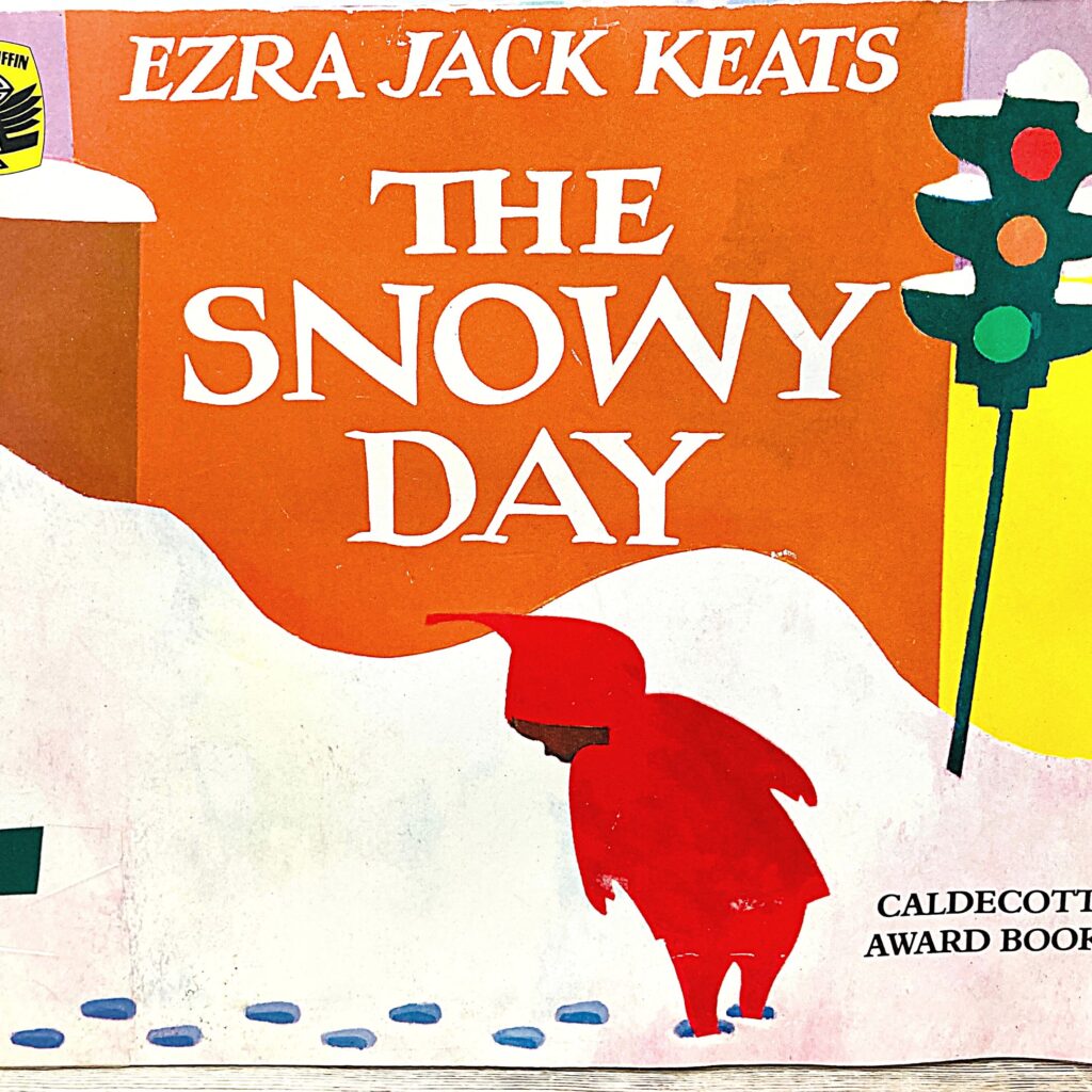 Images shows the cover of the book The Snowy Day with a boy walking in the snow