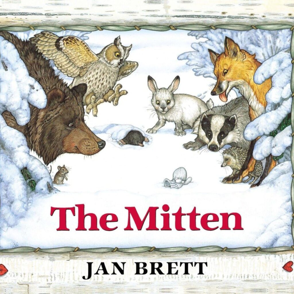The Cover of the Mitten shows many forest animals looking at a mitten in the snow